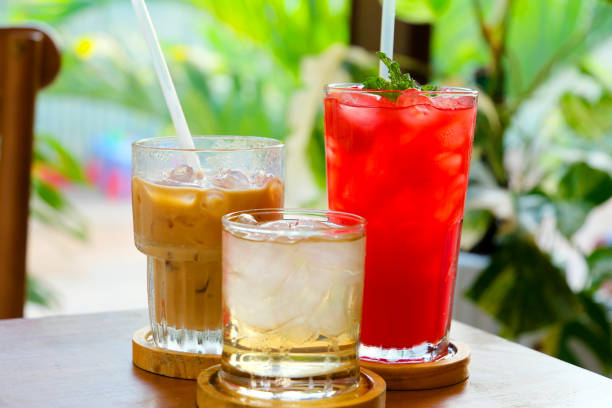 istock watermelon juice Aperol drink and bellini cocktail on white table with blue background. Sunshine and palm leaf shadow drink modern still life. Summer, party, tropical and freshness concept 2183366274