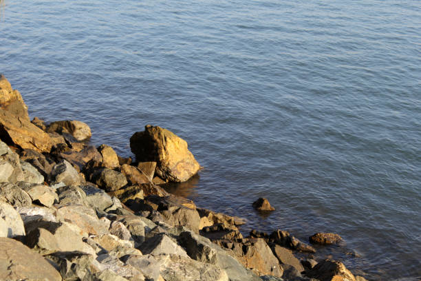 istock Rocky shoreline next to the ocean water 2183367327
