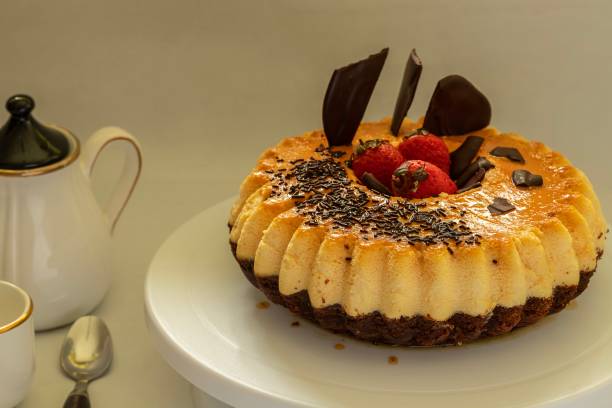 istock A chocolate cake with flan (chocoflan) on a white cake plate and a white dark background. 2183368300