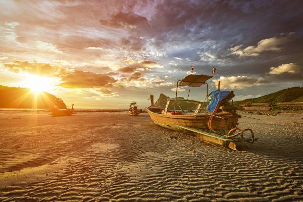 istock Long tail boat at beach on sunset 2183368684