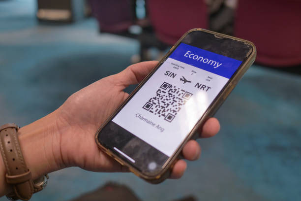 istock Passenger looking at E boarding Pass on phone airport 2183369091