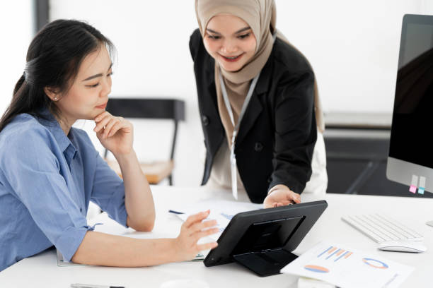 istock Happy female entrepreneurs using a tablet as they brainstorm ideas for their business. Two business women working as a team to achieve success 2183370169