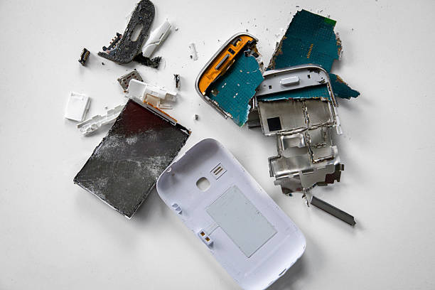 istock Shattered smartphone with small pieces on white table - top view 2183371685