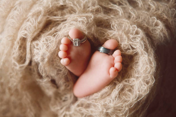 Children's tiny feet with rings on fingers