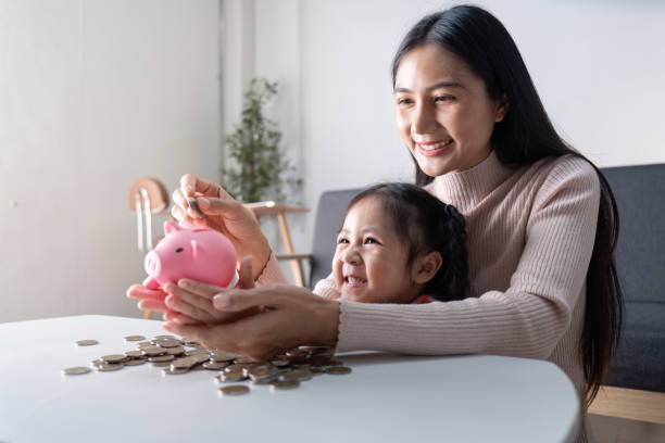 istock Joyful Lessons in Savings Mom Teaches Daughter Financial Responsibility 2183382715