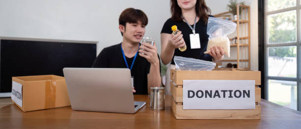 istock Charity Volunteers Preparing Food Donations for Distribution 2183384641