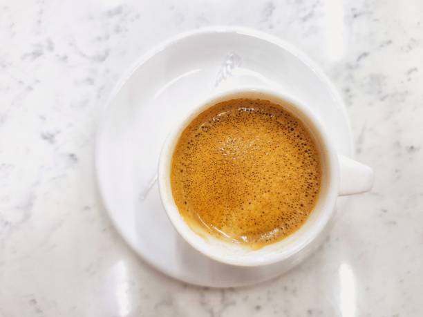 istock White cup of espresso coffee on a white table 2183391469