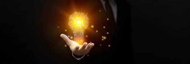 istock Businessman showing circuit light bulb icon is glowing light against dark background. Artificial intelligence idea concept. 2183393451