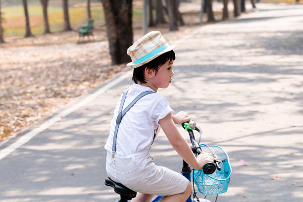 Happy young boy riding his bike.