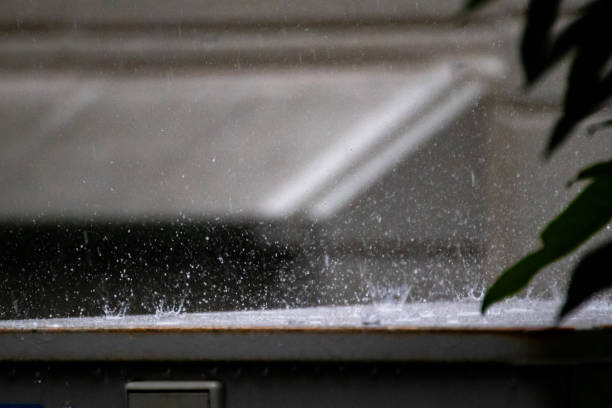 Rainwater falling heavily onto an outdoor iron plate