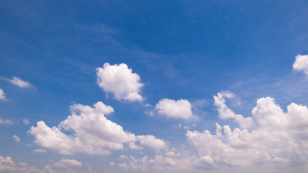 istock Panoramic view of clear blue sky and clouds, Blue sky background with tiny clouds. White fluffy clouds in the blue sky. Captivating stock photo featuring the mesmerizing beauty of the sky and clouds. 2183401610