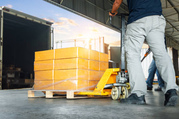 istock Workers Loading Pallets of Goods into The Truck. Package Boxes. Container Shipping. Loading Dock, Distribution Warehouse, Supply Chain, Supplies Shipment, Freight Truck Logistics Transportation. 2183403326