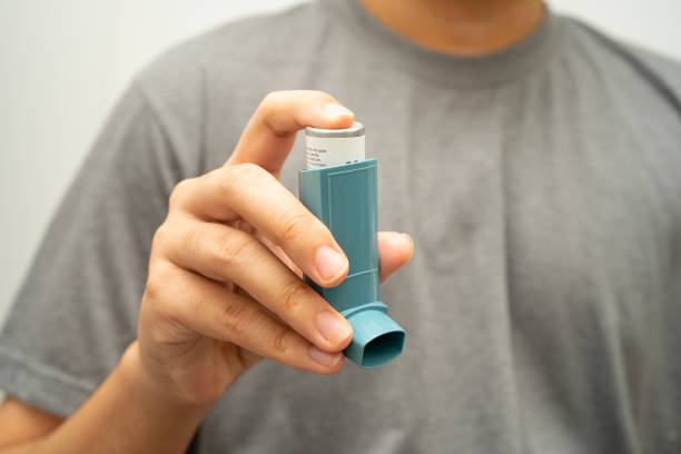 istock Asthma and chronic obstructive pulmonary disease COPD, Asian young man using metered dose inhaler MDI. 2183405243