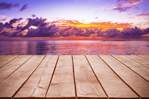 istock Empty wooden table top with tropical ocean sunset and dramatic sky background 2183407004