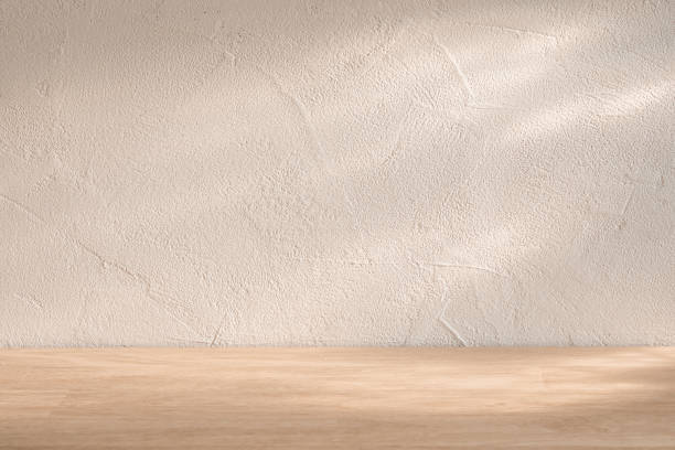 istock Minimalist wooden surface with textured wall background, softly lit, ideal for displaying products or food 2183407057