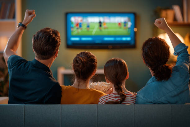 istock family watching sport at home 2183411025