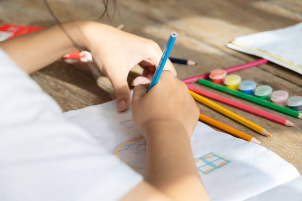 istock closeup student hand using colors pencil drawing art painting with imagine and creativity class 2183411259