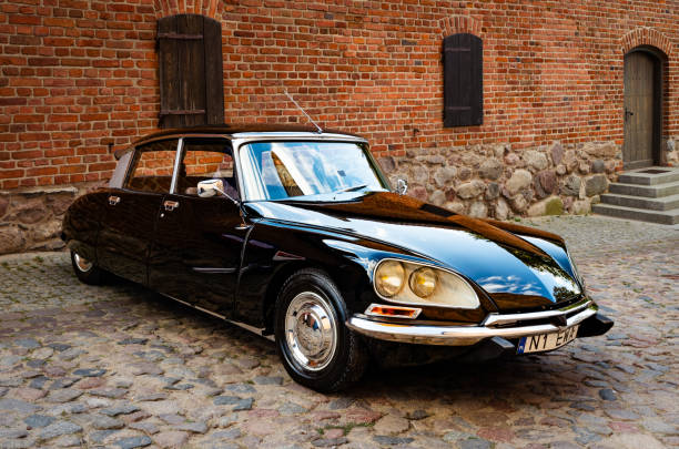 Paris, France - October 09, 2024: Beautiful classic car Citroen DS on the street with historic architecture. Vintage European cars
