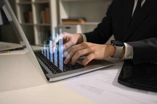 istock Hands of professional businessman working on financial data with virtual charts 2183418108