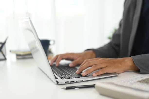 istock Close up of businessman typing on keyboard in modern workspace 2183418816
