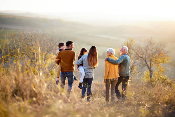 istock Back view of multi-generation family moving down the hill. 2183419229