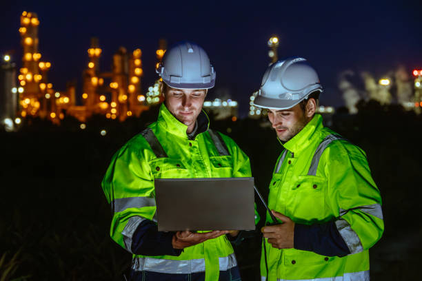 istock Night shift engineer oil and gas refinery service team worker hard work in petroleum industry plant light blur background. 2183419567