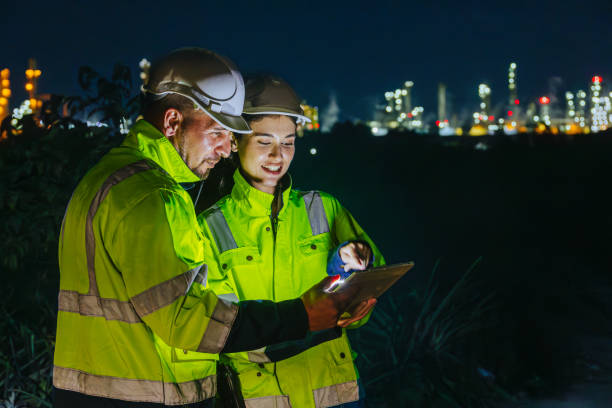 istock Night shift engineer oil and gas refinery service team worker hard work in petroleum industry plant light blur background. 2183419572