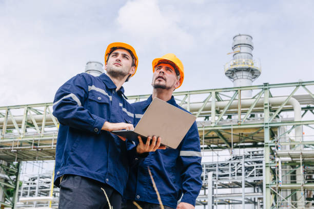 istock Engineer worker team working outdoor, Surveyor teamwork survey gas pipe oil transport pipeline deploy building project for refinery industry. 2183419687