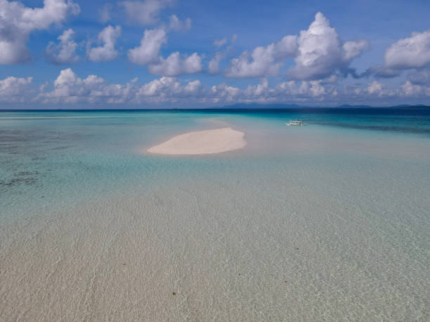 istock Isolated Sandbar in Clear Turquoise Waters Under Cloudy Sky 2183420097
