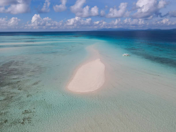 istock Isolated Sandbar in Clear Turquoise Waters Under Cloudy Sky 2183420098
