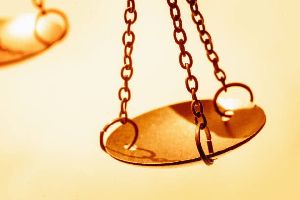 Scales of justice against white background. Selective focus. Copy space for text. Horizontal image.