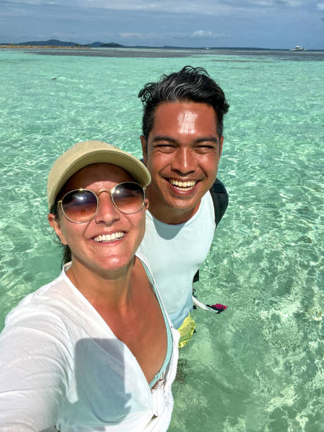 istock Happy Couple Taking Selfie in Clear Tropical Waters 2183420700
