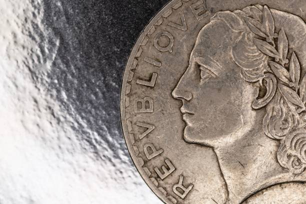 A stack of 20 Rappen Swiss Franc currency coins. Top view, isolated on blue, close up shot, no people.