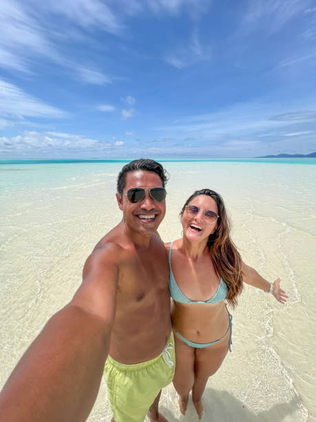 istock Happy Couple Taking Selfie in Shallow Tropical Waters 2183421562