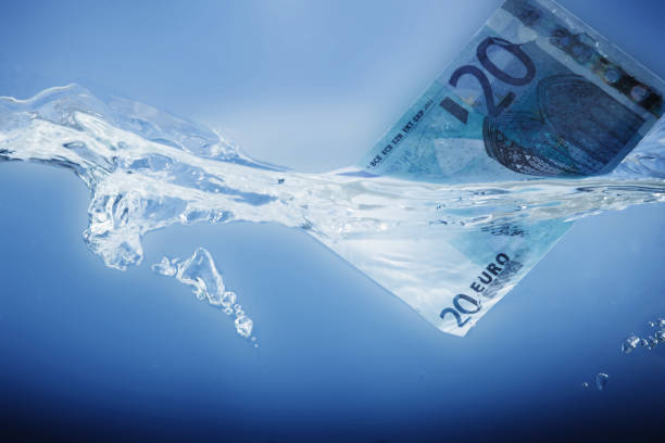 istock Conceptual image: European debt crisis.  Euro banknote sinking in water. 2183421825
