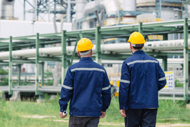 istock Engineer worker team working outdoor, Surveyor teamwork survey gas pipe oil transport pipeline deploy building project for refinery industry. 2183424558