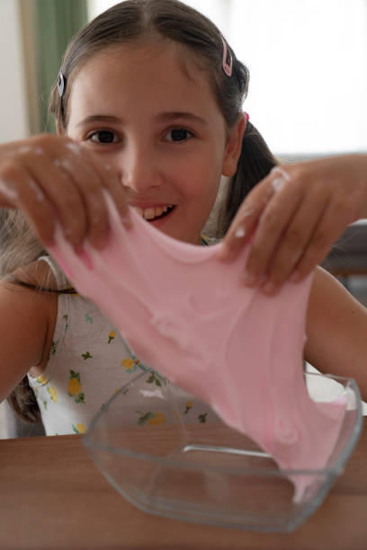 istock Girl playing with sticky slime 2183425692