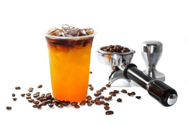 istock Americano ice coffee mix with orange juice and coffee beans spread, tamper, isolate and white background concept. 2183429710