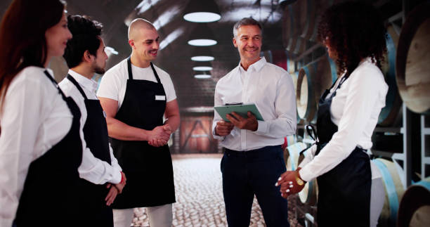 istock Store Manager In Wine Cellar Meeting With Team 2183439334