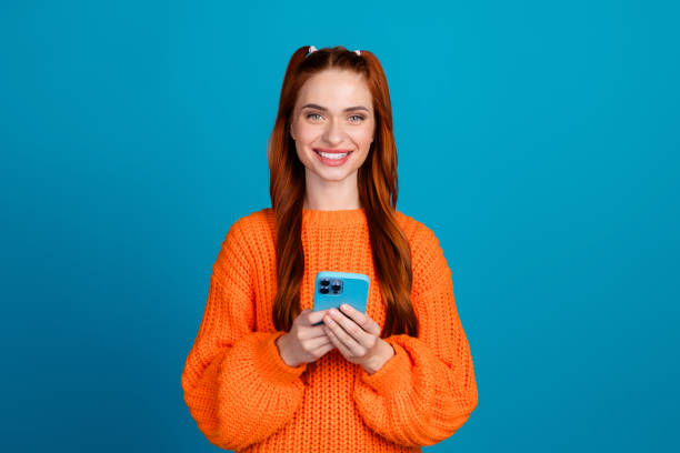 istock Photo of shiny attractive lady dressed knitted pullover communicating modern gadget empty space isolated blue color background 2183440187