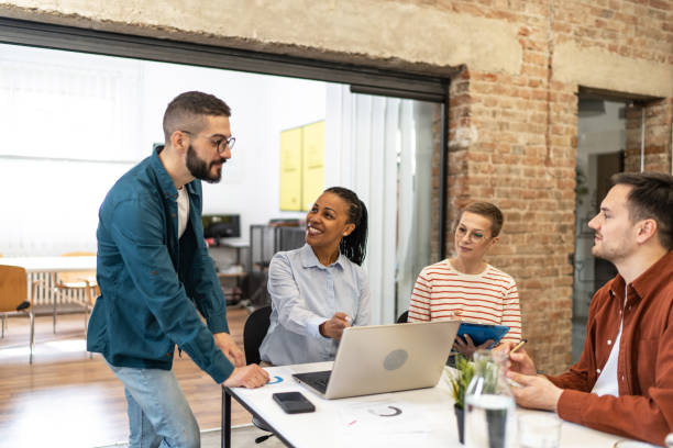 istock Diverse group of co-workers having casual discussion in office 2183441455