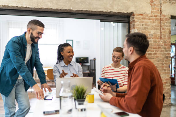 istock Diverse group of co-workers having casual discussion in office 2183441552