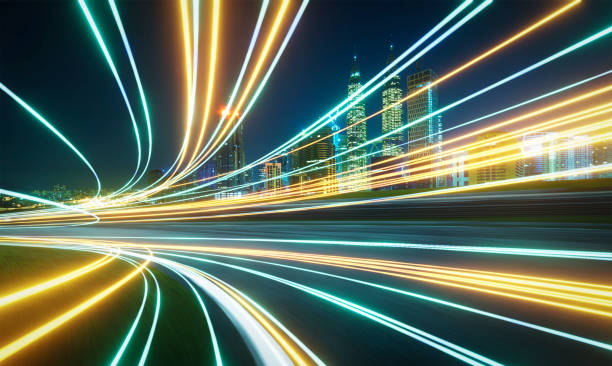 istock Light trails illuminating a modern city with skyscrapers at night 2183444203