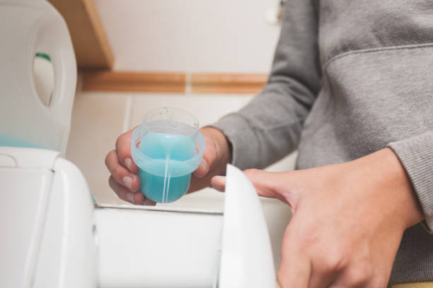 istock A person pours detergent into a washing machine. 2183445108