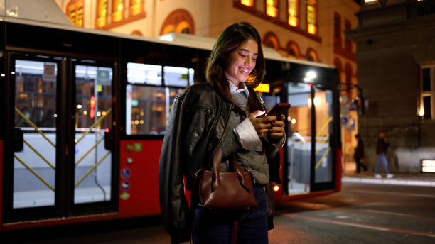 istock Happy woman texting on smartphone while taking a walk downtown in the evening 2183447248