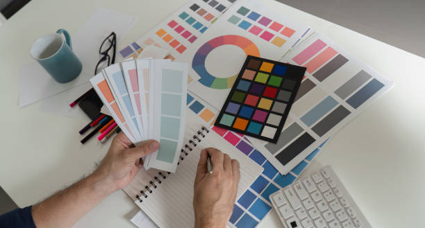 istock Creative Graphic Designer Selecting Color Palettes for Innovative Design Projects in Modern Workspace 2183447490
