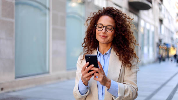 istock Woman enjoying a city walk and using smartphone 2183452987