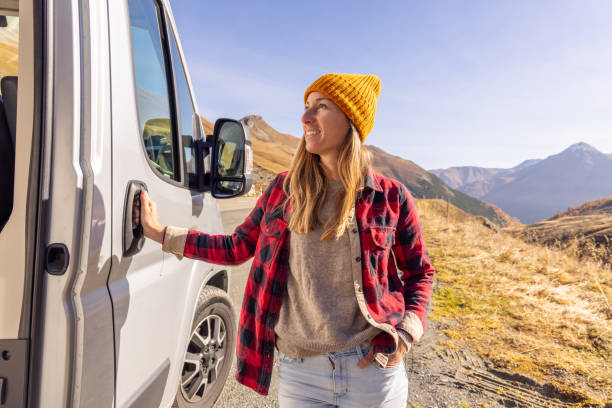 istock Woman Embracing Adventure by Camper Van in the Mountains 2183454813