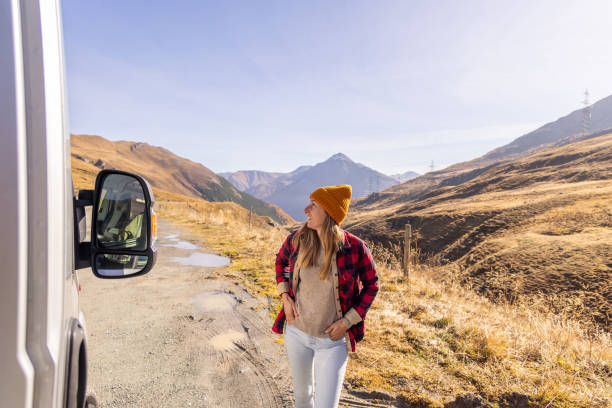 istock Woman Enjoying Mountain Scenery by Camper Van 2183455032