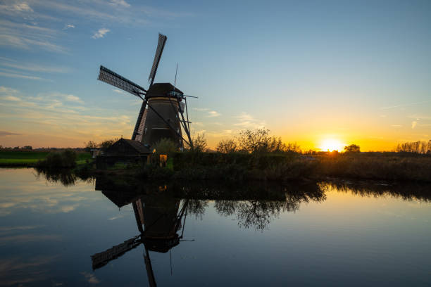 istock panoramic view of a windmill at sunset with reflection in the water, kinderdijk in Netherlands 2183455895